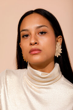 Stylish woman wearing gold earrings 