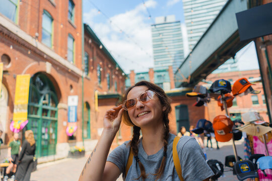 Woman  in sunglasses  in Distillery district in Toronto, Canada 