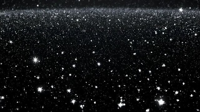 Thousands of tiny sparkling white dots and star shapes scattered across a black, dark background