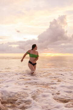 Woman enjoying the sea at sunset