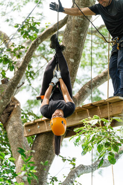 Woman enjoying an inverted descent in an outdoor adventure