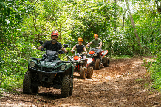 Group riding ATVs in the forest