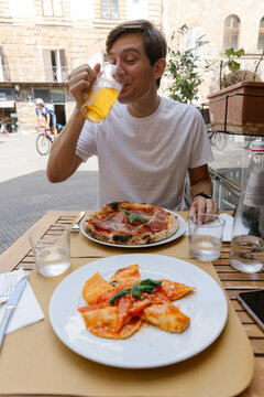 Tourist enjoying plate of food in Italy