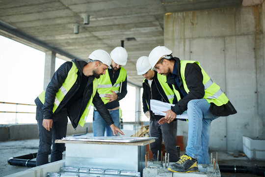Group of engineers discussing project on site