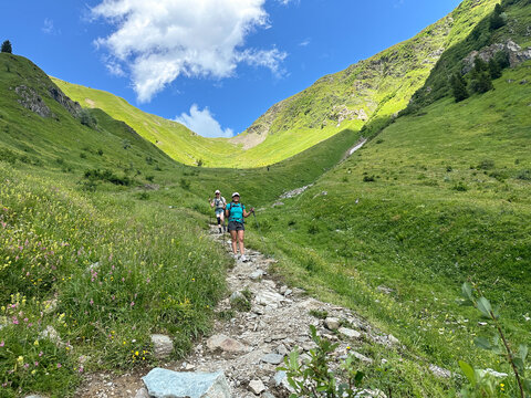 UGC of young women descending a trail on  the Tour du Mont Blanc, Alps