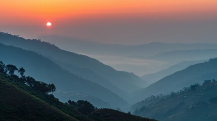 Fototapeta premium Serene Sunrise Over Misty Mountains with Soft Colors of Dawn Lighting Up the Horizon and Casting Shadows on the Landscape Beneath