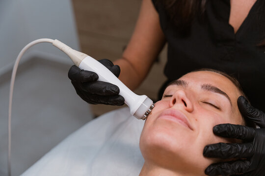 Beautician performing facial skin treatment 
