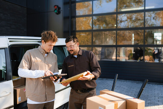 Men unload parcels from the car