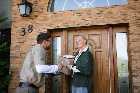 The postman delivers the parcel to the customer