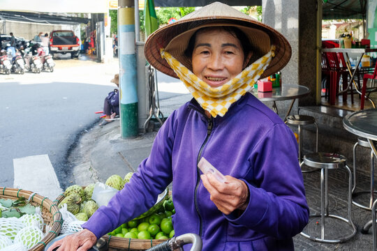  Street Vendor with Vietnamese Banknote