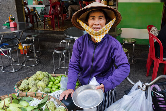 Smiling Street Vendor in Purple