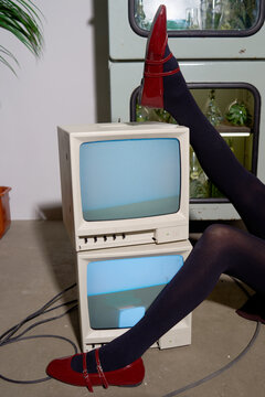 Unique art installation featuring retro monitors and stylish footwear 