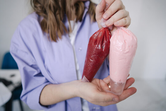 Person holds pastry bags