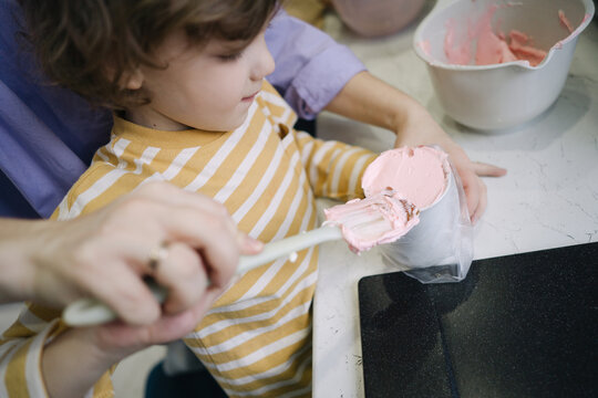 Mother and son cooking cream