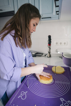 Woman sponge cake in the kitchen