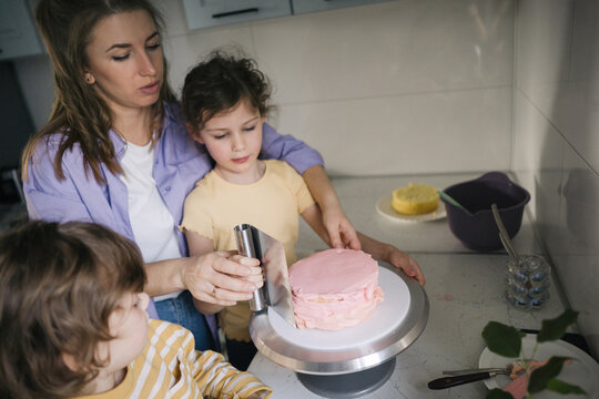 Mother and two kids on the kitchen