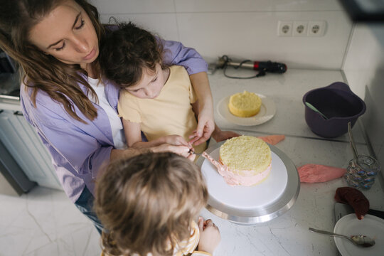 Family making cake at home