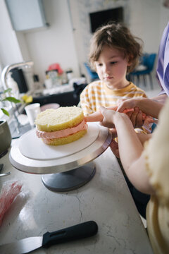 Mom and son making a sweet cake