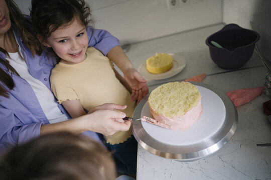 Family making a cake at home