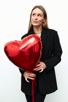 A woman with a red heart-shaped balloon