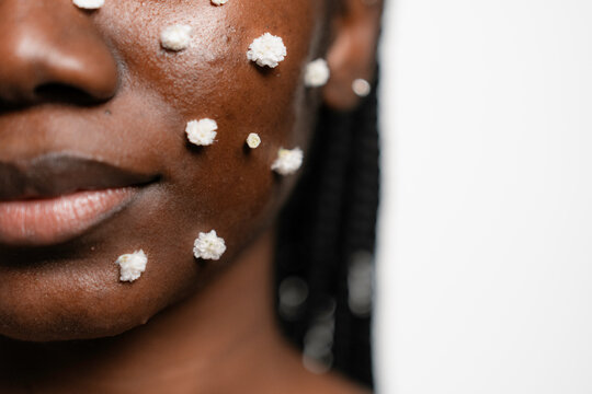 Small white flowers on a woman's face