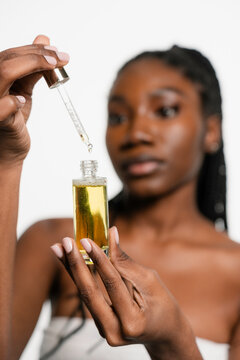 A woman holds a cosmetic product in her hands