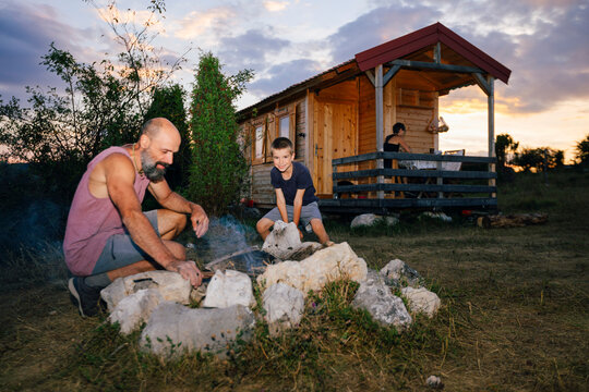 Family Relaxing in Front Yard of their Remote Home