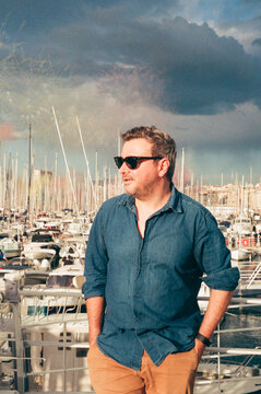 Male model in Sunglasses standing at Marina