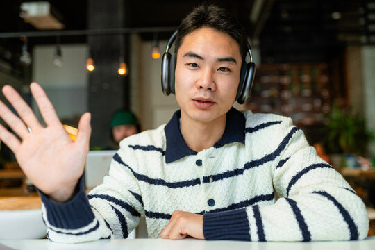 A man is talking on a video chat looking at the camera