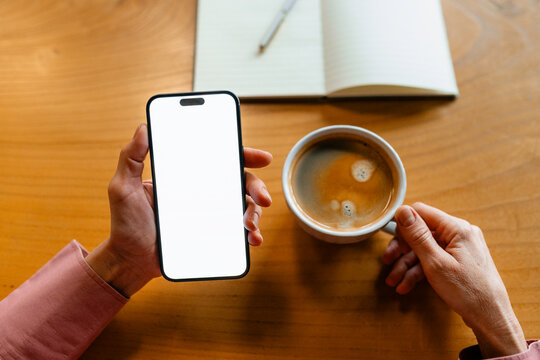 Woman's hands with white-screen mobile phone