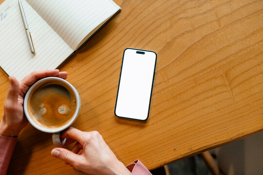 A mobile phone with white screen on the table