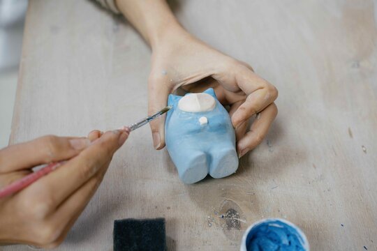 The Hands Of A Woman Working On A Product