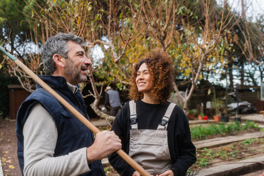 Happy Gardeners Engaged In Cheerful Conversation