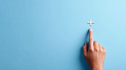 Naklejka premium Hand pointing towards plus sign on blue background for design elements