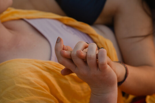 Intertwined Hands of LGBTQ Couple at the Beach