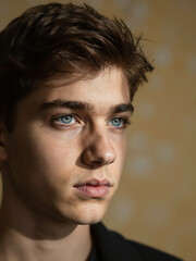Obraz premium Close Up Portrait Of Serious Young Caucasian Man With Blue Eyes Looking Away