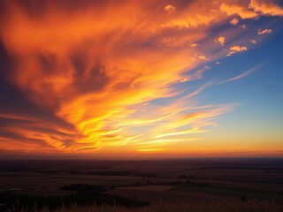 Obraz premium Vast sky ablaze with fiery sunset hues, casting golden light across a tranquil landscape , twilight, colors