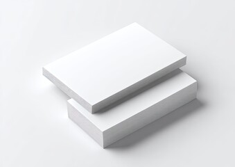 Stacked white rectangular paper products on a neutral surface with soft shadows