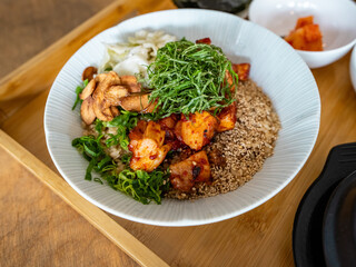 Fototapeta premium Colorful Korean Bibimbap with Mixed Vegetables and Sesame Seeds