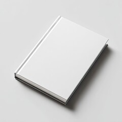 A blank hardcover book, angled slightly, sits on a plain white surface. Minimalist and clean