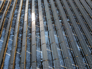 Obraz premium Close-up of Solar Panel Arrays Covered in Snow, Photovoltaic Power Station on High Altitude Plateau, Renewable Energy