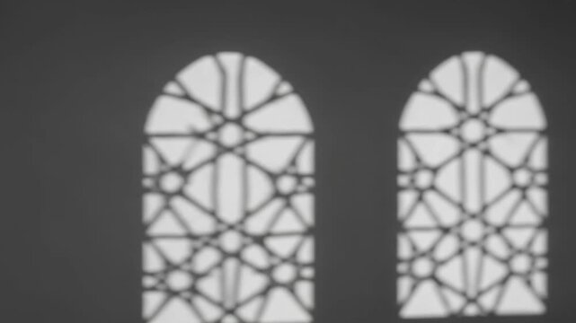 Islamic Arched Window Shadow Overlay on Dark Wall.