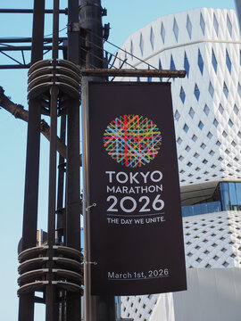 TOKYO, JAPAN - February 19, 2026: Banner on a lamppost advertising the Tokyo Marathon 2026. Ginza Place is in the background.