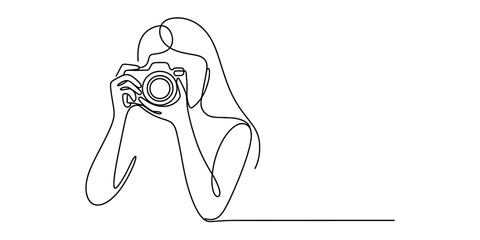 Continuous line drawing of a woman photographer holding a professional camera to her eye. © Bobita