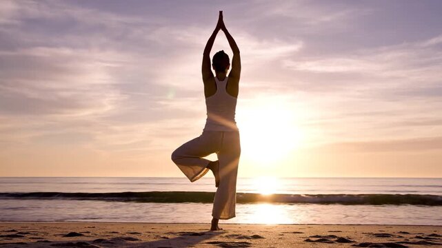 Woman Practicing Yoga on Beach at Sunset.