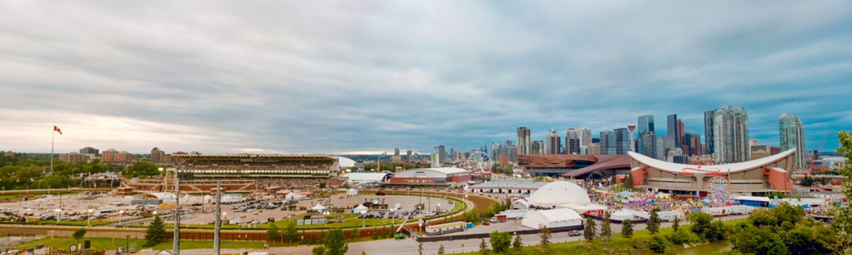 Calgary, Alberta, Canada. February 20, 2026. Panoramic view of the Calgary Stampede grounds featuring the Scotiabank Saddledome and BMO Centre under a cloudy sky.