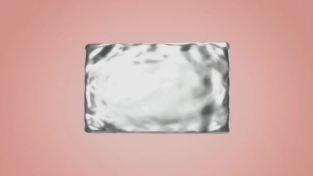 A single, rectangular, silver-wrapped candy or confection rests on a soft pink background.