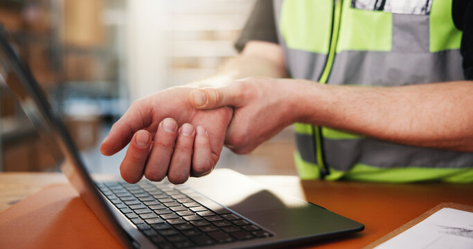 Logistics, laptop and hands with wrist pain in warehouse from carpal tunnel, injury or work accident. Shipping, tech or person with joint strain at distribution depot for tendinitis or muscle tension