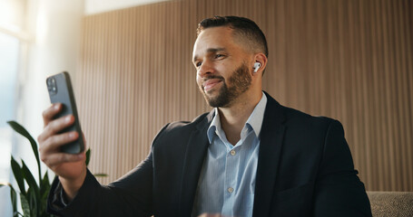Naklejka premium Business, man and phone with earphones in office for social media, streaming podcast and chat. Male person, reading and mobile to download playlist, listening to music and subscription for work break