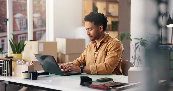 Laptop, logistics and businessman in office with research for online delivery information. Computer, typing and male supply chain manager with email for shipping communication by boxes in workplace.